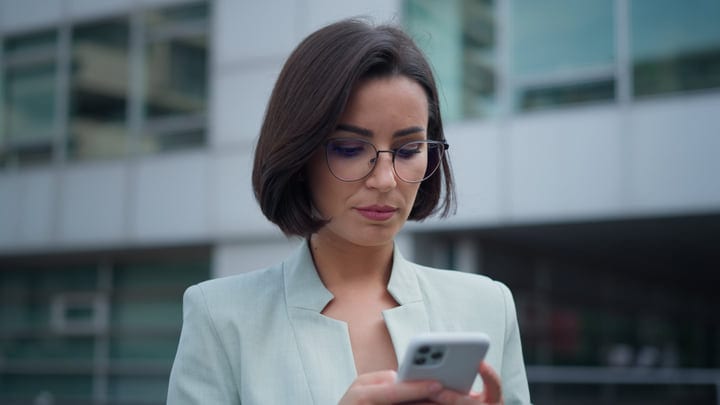 Modern Businesswoman Engaged with Her Smartphone in Vienna