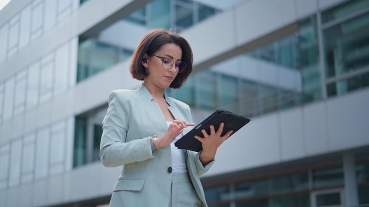 Focused Businesswoman Navigating Her Tablet In Vienna