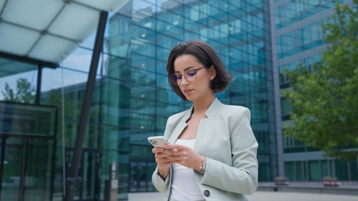 Confident Businesswoman Checks Her Phone In Vienna's Urban Landscape