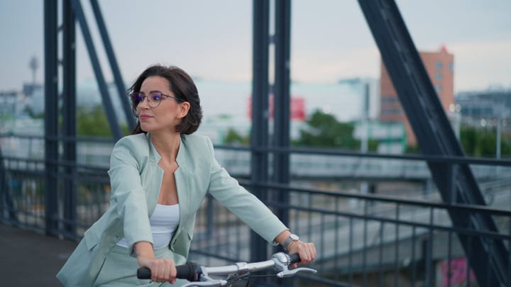 Confident Woman Biking Through Vienna's Urban Landscape