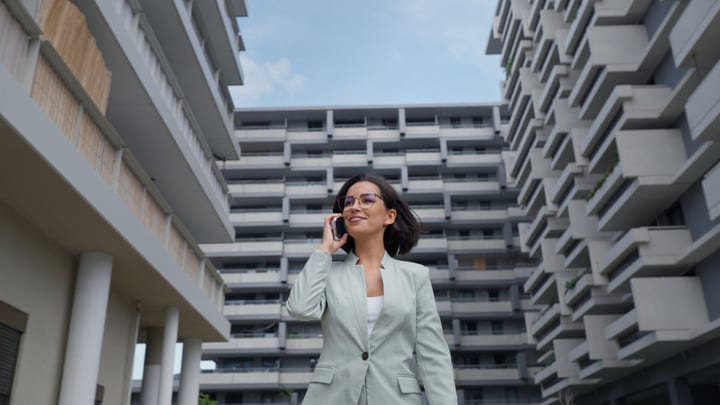 Confident Businesswoman Takes A Call Amidst Vienna's Architecture