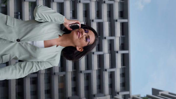 Confident Businesswoman Engages in Call Amid Urban Backdrop