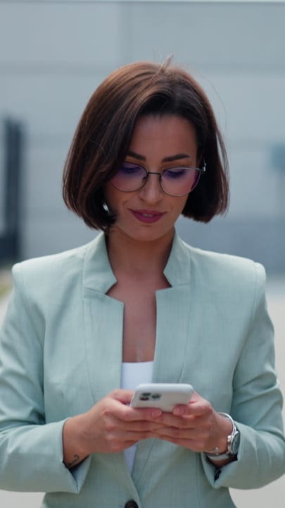 Businesswoman Engages With Technology In Vienna's Vibrant Streets