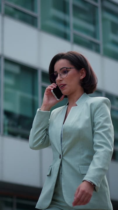 Confident Businesswoman Takes Call in Vienna's Urban Landscape
