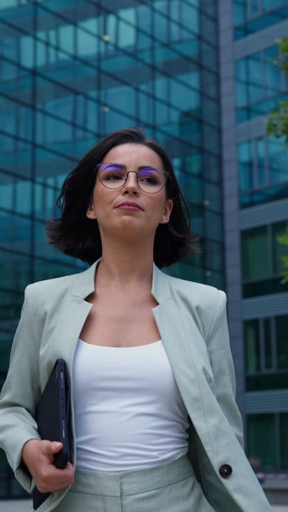 Confident Businesswoman Walking Through Modern Vienna Streets
