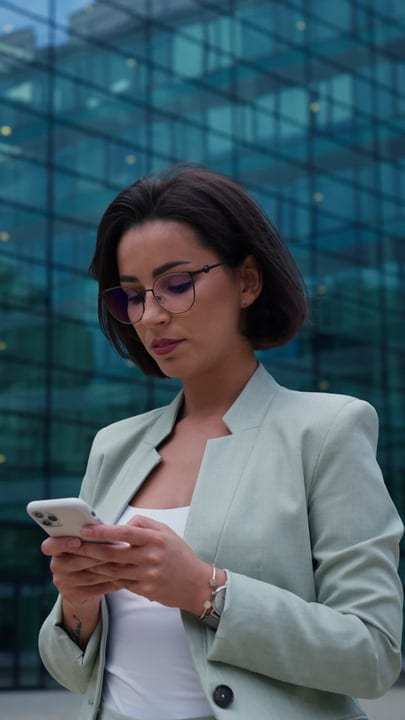 Focused Businesswoman Checks Her Phone In Vienna's Urban Scene