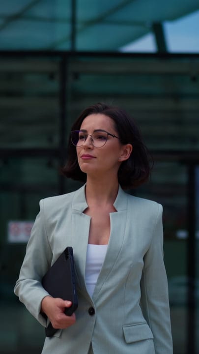 Confident Businesswoman Strolling Through Vienna's Modern Streets