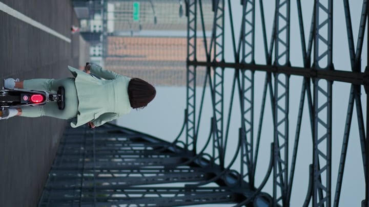 Businesswoman Rides Bicycle Across Vienna Bridge