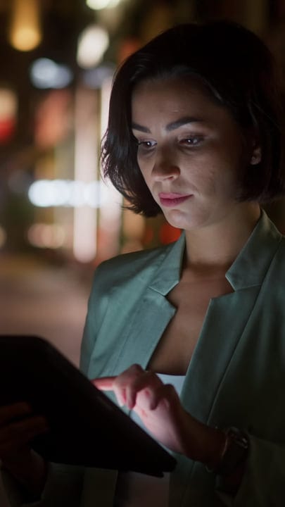 Focused Businesswoman Engages with Her Tablet in Vienna Evening