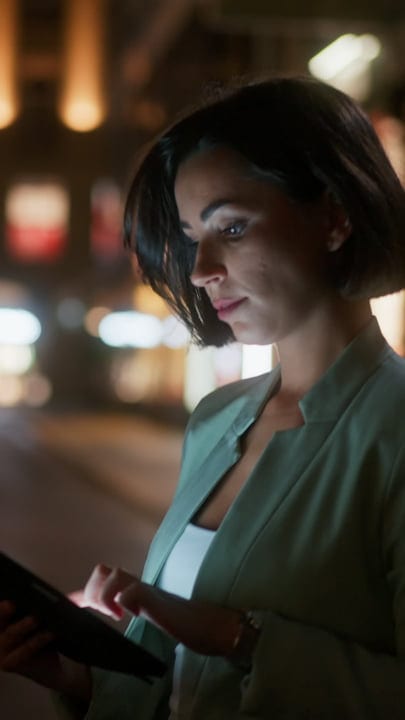 Businesswoman Engages With Tablet Under Vienna's Night Lights