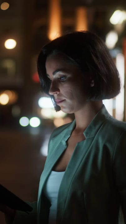 Businesswoman Engaged With Her Tablet Under Vienna's Night Sky