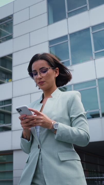 Modern Businesswoman Engaged With Smartphone In Vienna Cityscape