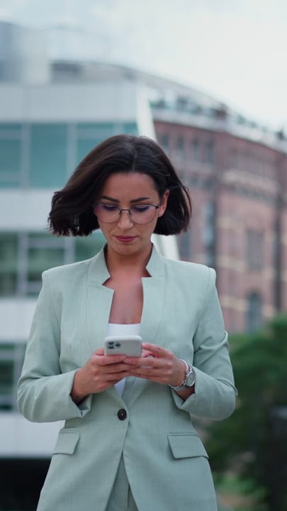Focused Businesswoman Checks Her Phone In Vienna Streets