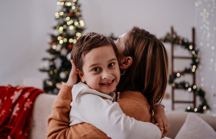 A Child's Joyful Embrace During Holiday Decorating