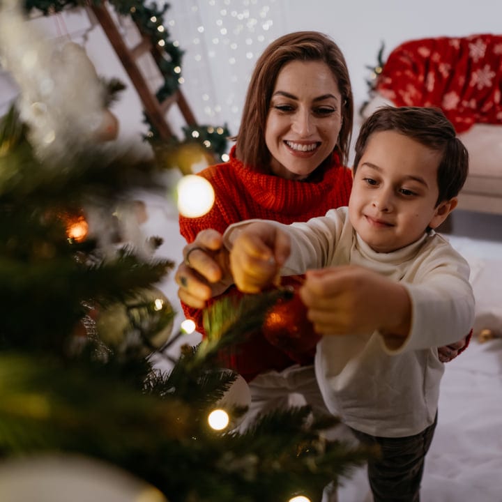 A Mother and Child Share Christmas Tree Magic Together
