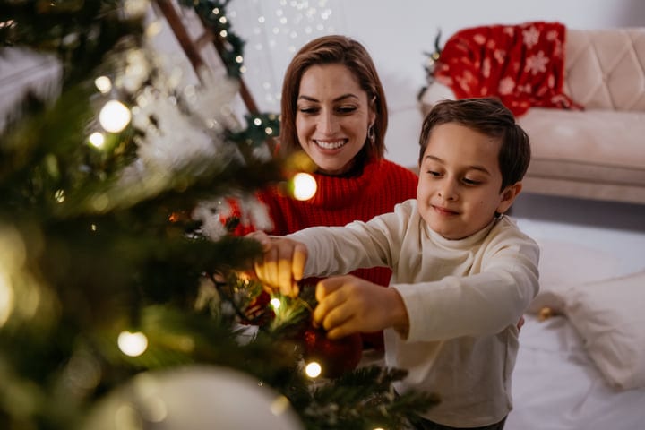 A Child's Delight In Holiday Tree Decorating Magic