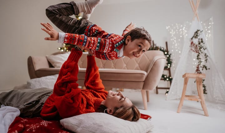 Mother and Son Soar in Joyful Christmas Playtime