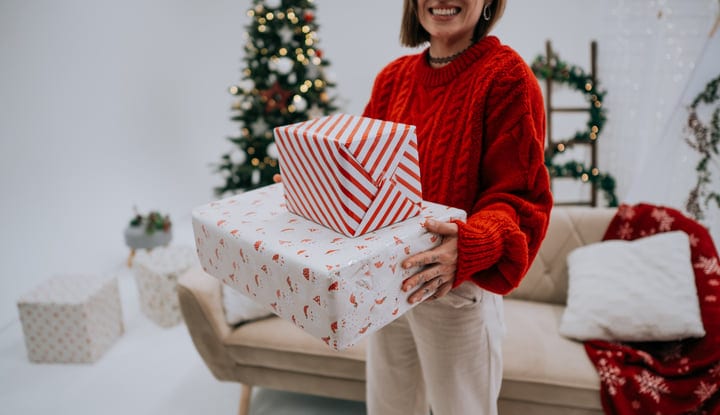 Joyful Holiday Spirit With Gifts Near The Christmas Tree