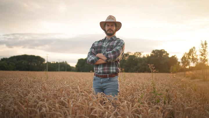Confident Farmer Stands Proudly In Golden Wheat Field