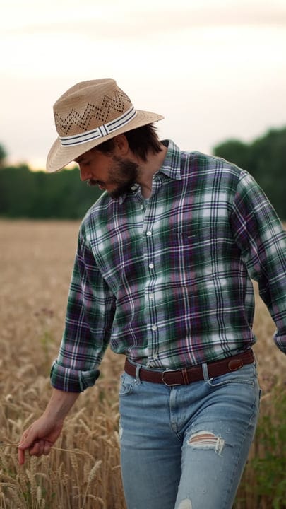 A Farmer Embraces Tradition In A Modern Wheat Field
