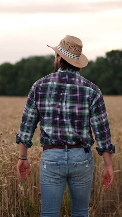 A Farmer Embraces the Harvest in Golden Wheat Fields