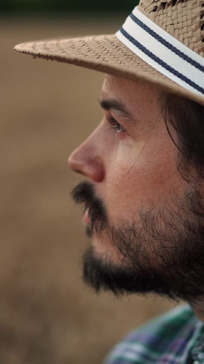 A Farmer Gazes Thoughtfully Across His Fields