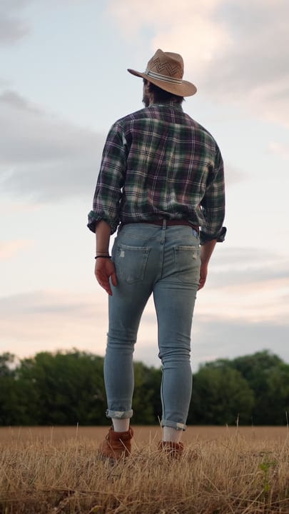 Farmer in Plaid Shirt Enjoys Crisp Morning Sky