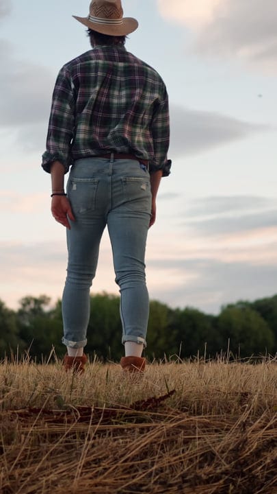 Farmer Surveys Evening Fields With Quiet Resolve