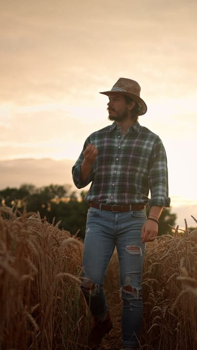 Contemplative Farmer Embraces Technology In Golden Fields
