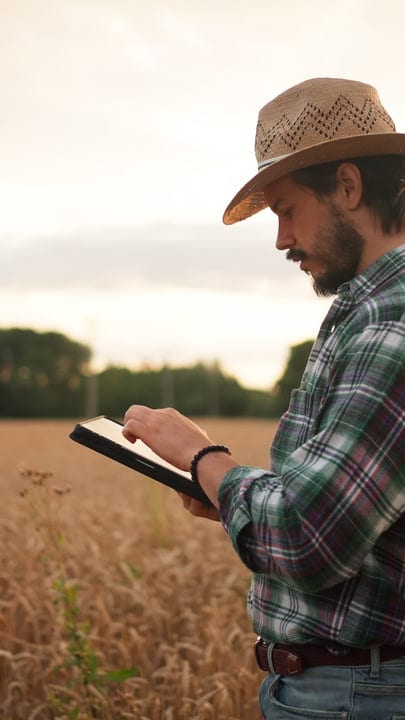 Digital Savvy Farmer Embraces Technology in Wheat Field