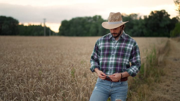 A Farmer Connects With The Land At Dusk