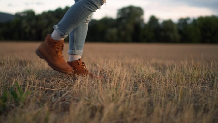 Sturdy Boots Tread Across A Sunlit Field