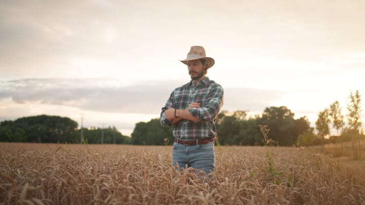 Contemplative Farmer Embraces Evening Calm in Wheat Field