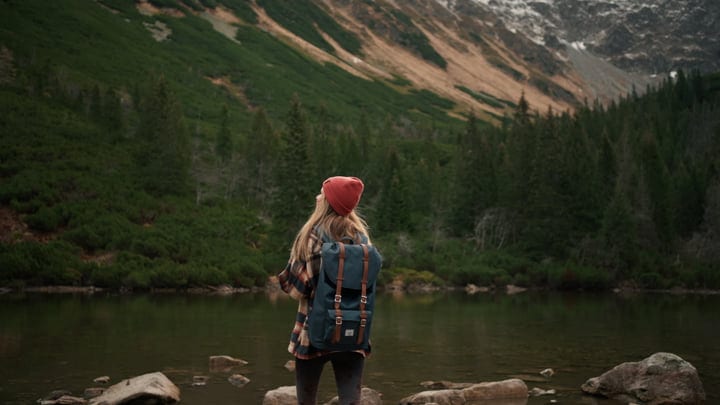 Solo Adventurer Contemplates Serene Mountain View