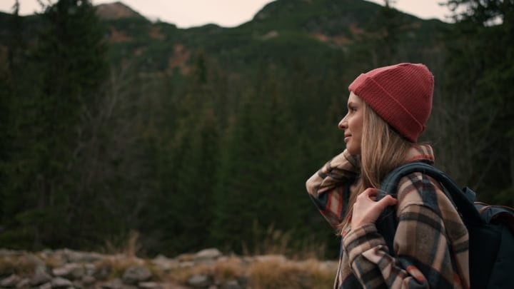 Young Woman Embraces Nature On A Mountain Hike