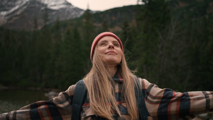 Joyful Hiker Embraces Nature In Mountain Wilderness