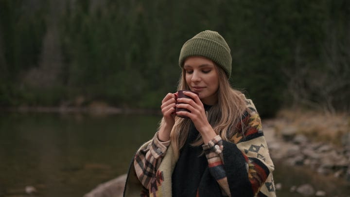 Warm Sips Amidst the Tranquil Wilderness Landscape
