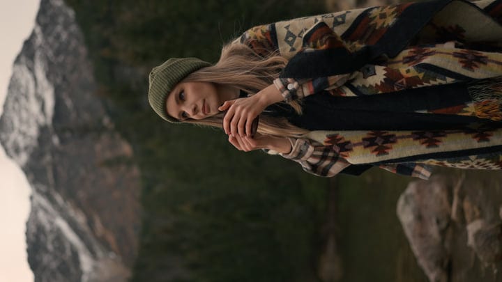 Woman Embraces Tranquility With Warm Drink In Nature