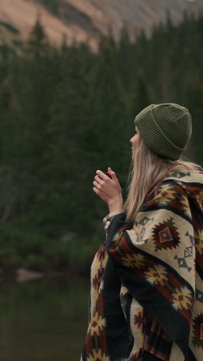 A Hiker Embraces Tranquility Wrapped In A Cozy Blanket
