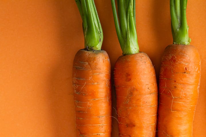 Vibrant Carrots Freshly Harvested On A Rustic Surface