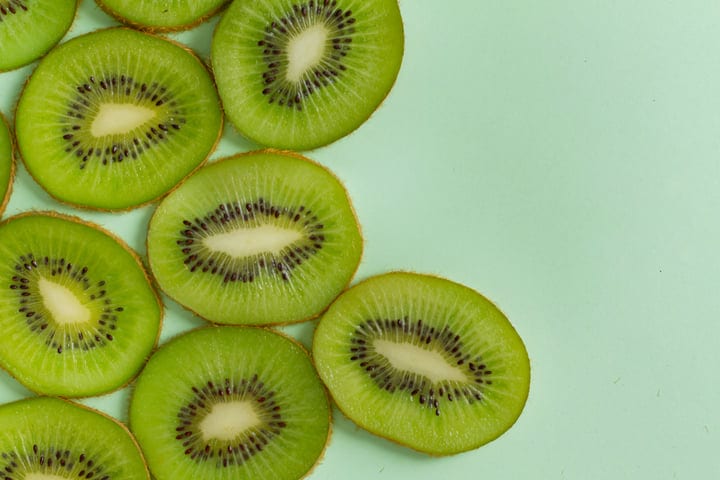 Sliced Kiwi on Mint Green Background Brings Freshness