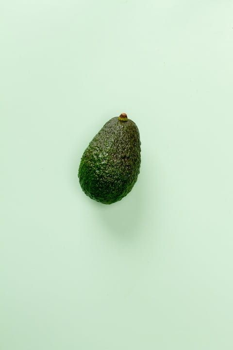 Avocado Solitude on Soft Pastel Backdrop