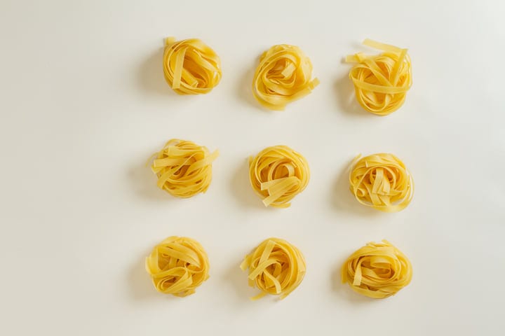 Golden Pasta Nests Arranged in Minimalist Flatlay