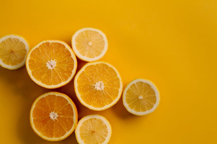 Vibrant Citrus Halves on Bold Yellow Background