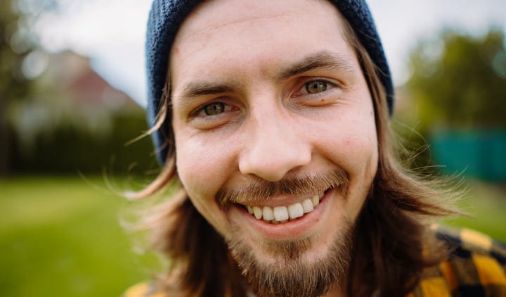 A Gardener's Joyful Expression Amidst Spring Growth