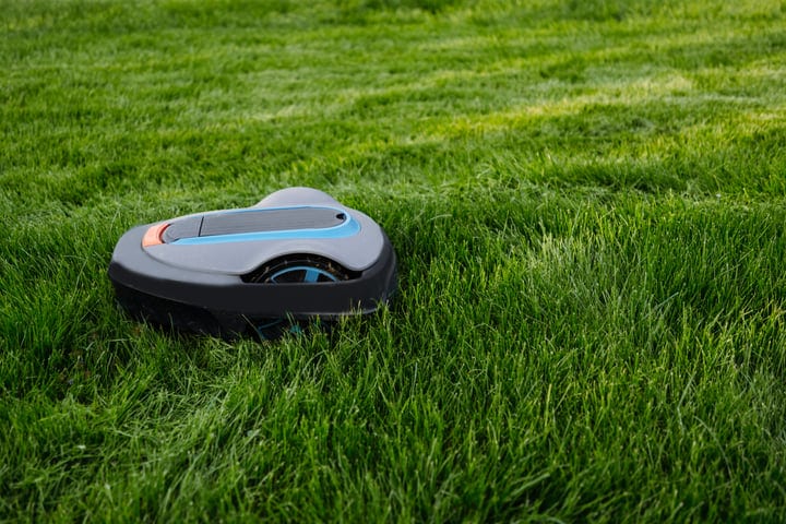 Smart Robot Mower Glides Effortlessly Over Green Lawn