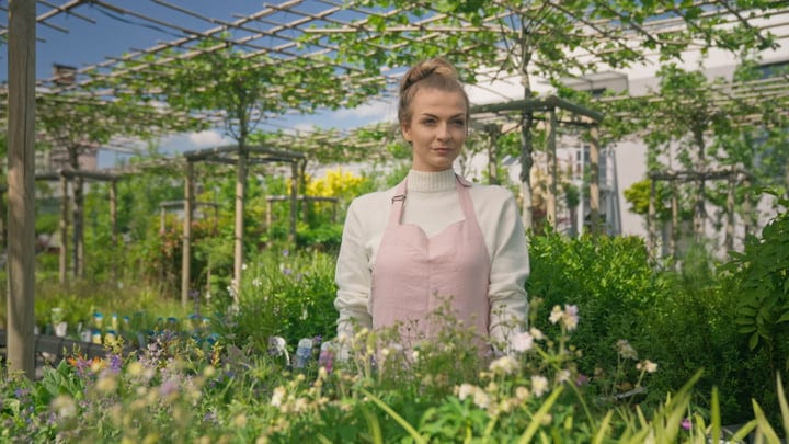 Young Gardener Embraces Nature's Beauty In Greenhouse Serenity
