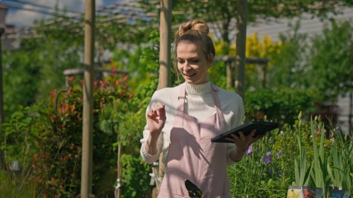 A Gardener Embraces Springtime Tasks in Greenhouse