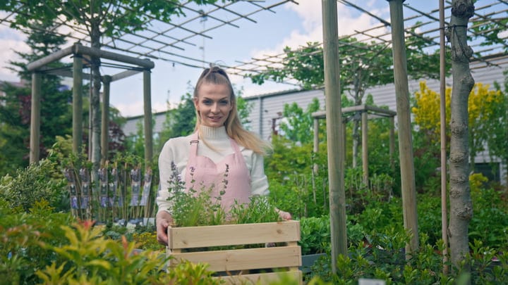Joyful Gardener Tending to Her Greenhouse Oasis