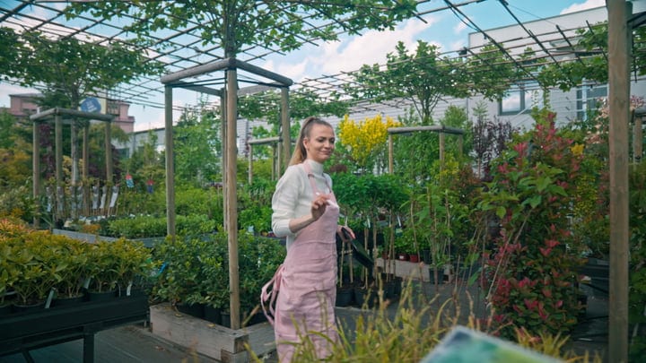 A Gardener Strolls Through Her Lush Greenhouse Oasis